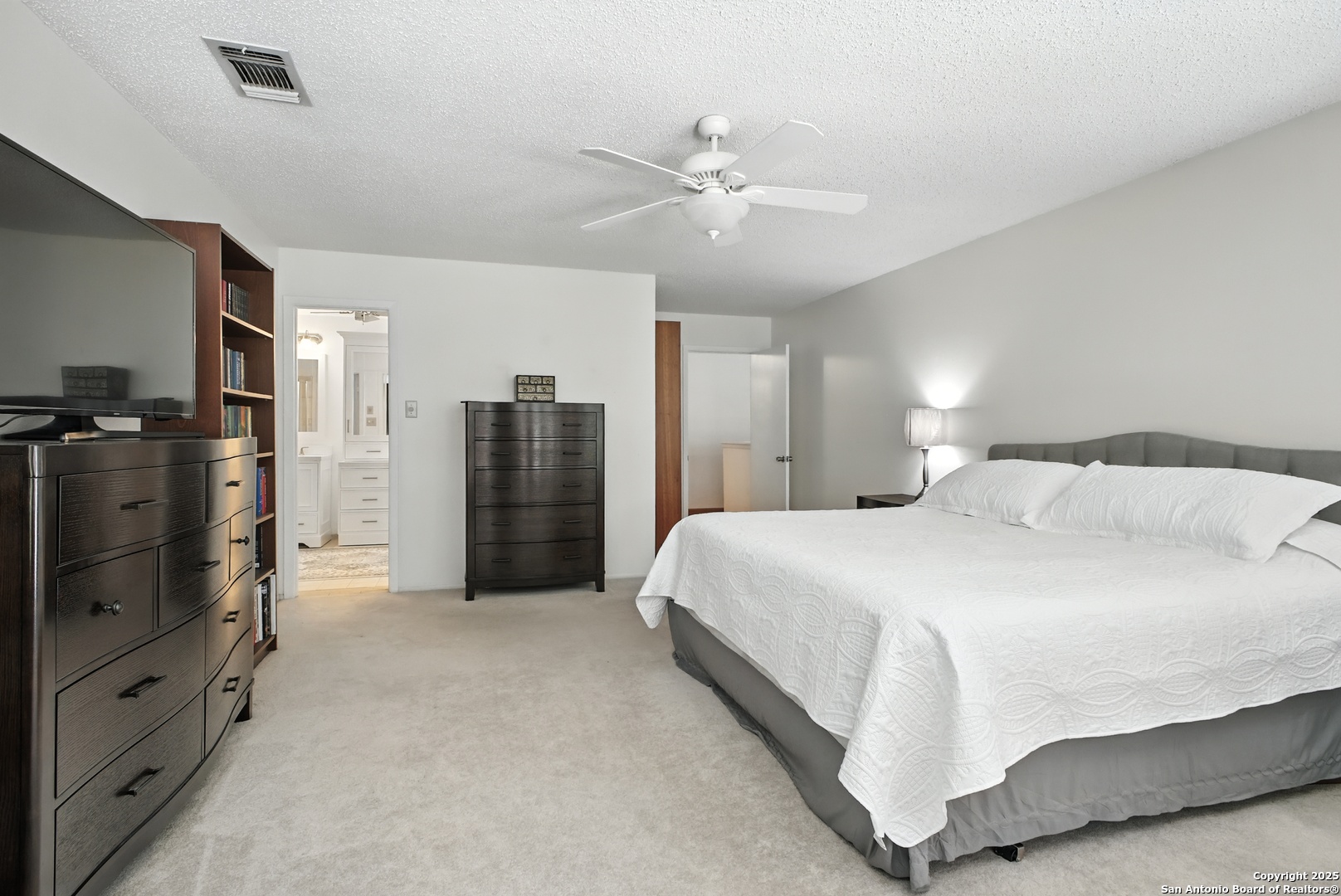 16414 Bulverde Point San Antonio, TX 78247 - Photo 25 of 46 a spacious bedroom with a bed and a walk in closet