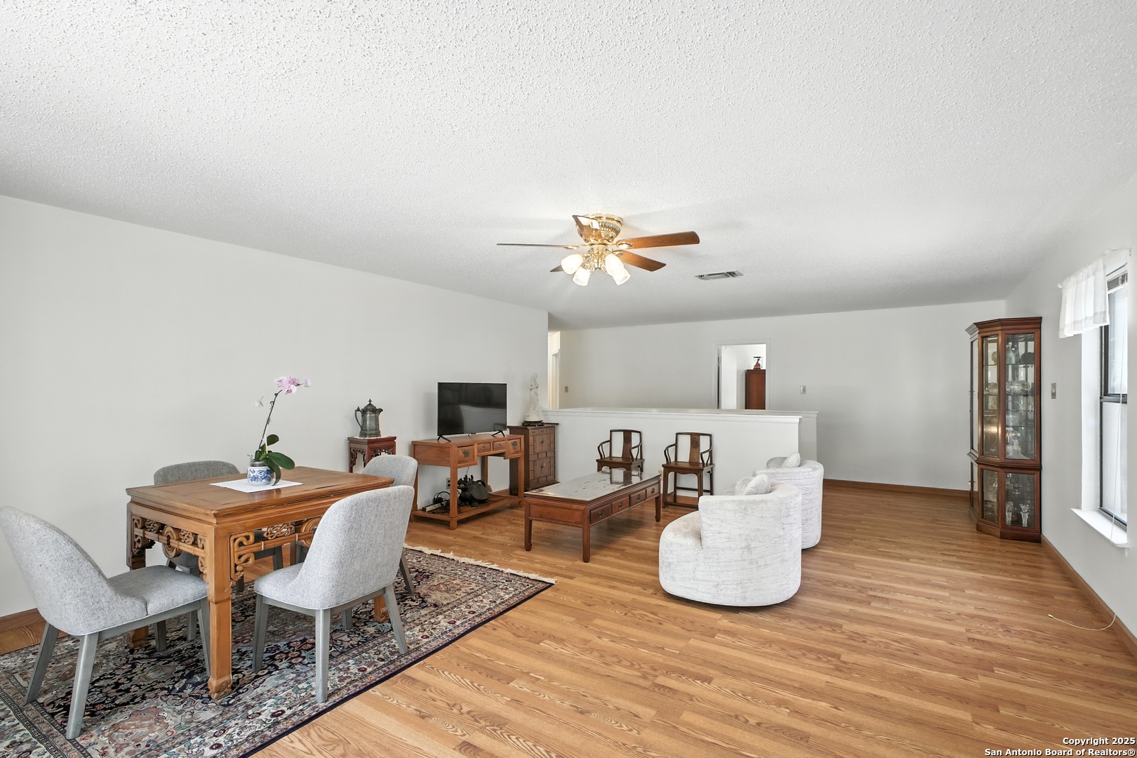 16414 Bulverde Point San Antonio, TX 78247 - Photo 33 of 46 a living room with furniture a fireplace and a table
