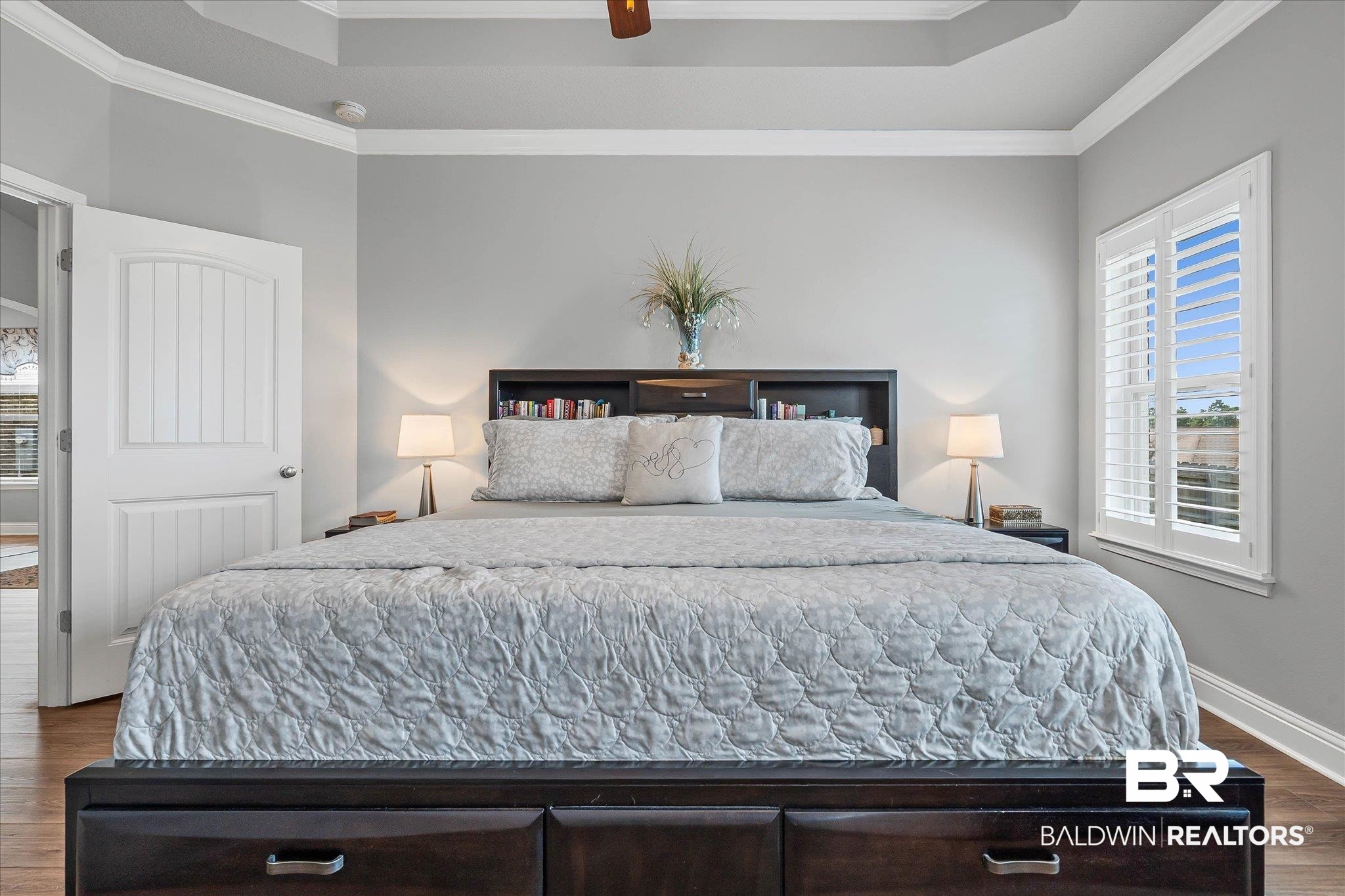 10677 Orkney Way Spanish Fort, AL 36527 - Photo 9 of 22 Bedroom with dark wood-style floors, ornamental molding, ceiling fan, and a tray ceiling