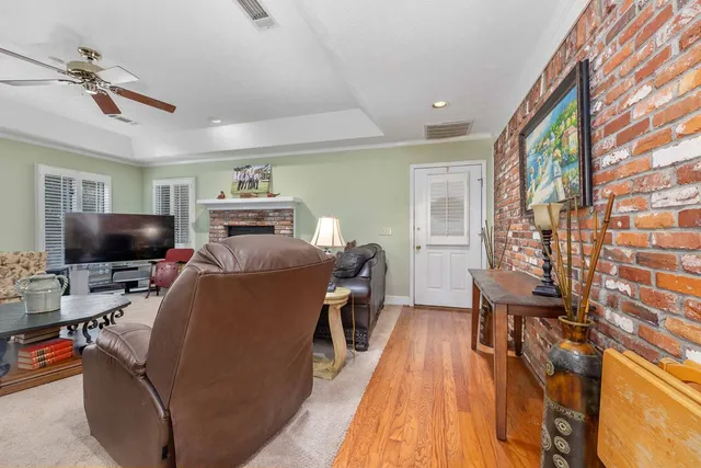 a living room with furniture fireplace and a table
