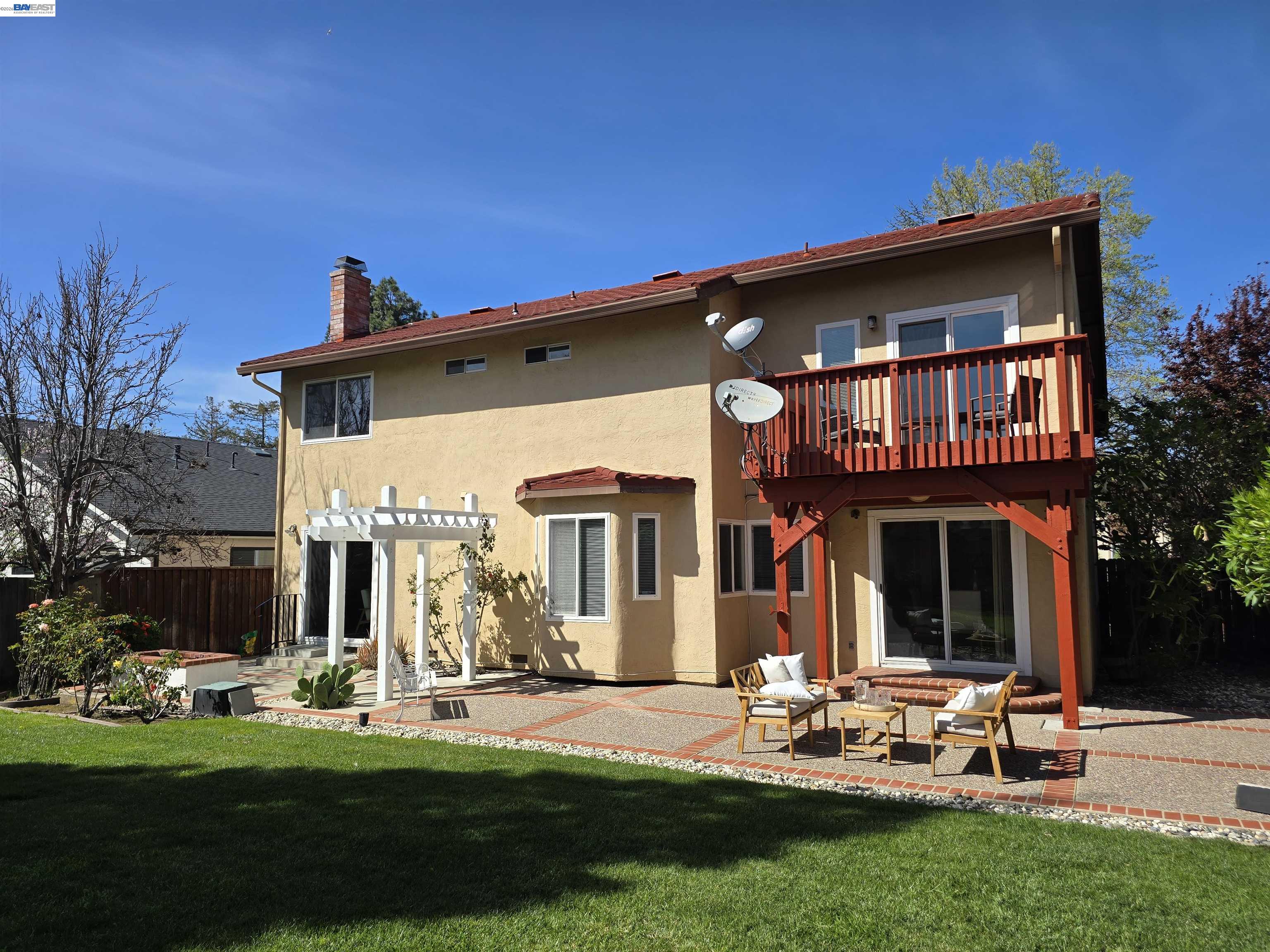 a view of a house with backyard sitting area and garden
