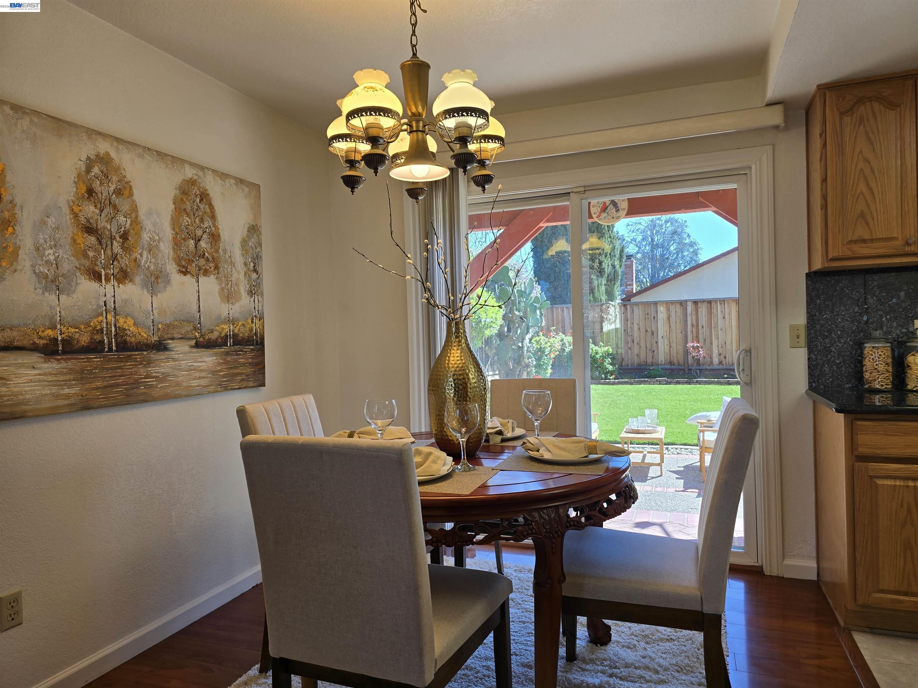 161 Hackamore Lane Fremont, CA 94539 - Photo 15 of 60 a view of a dining room with furniture a chandelier and wooden floor
