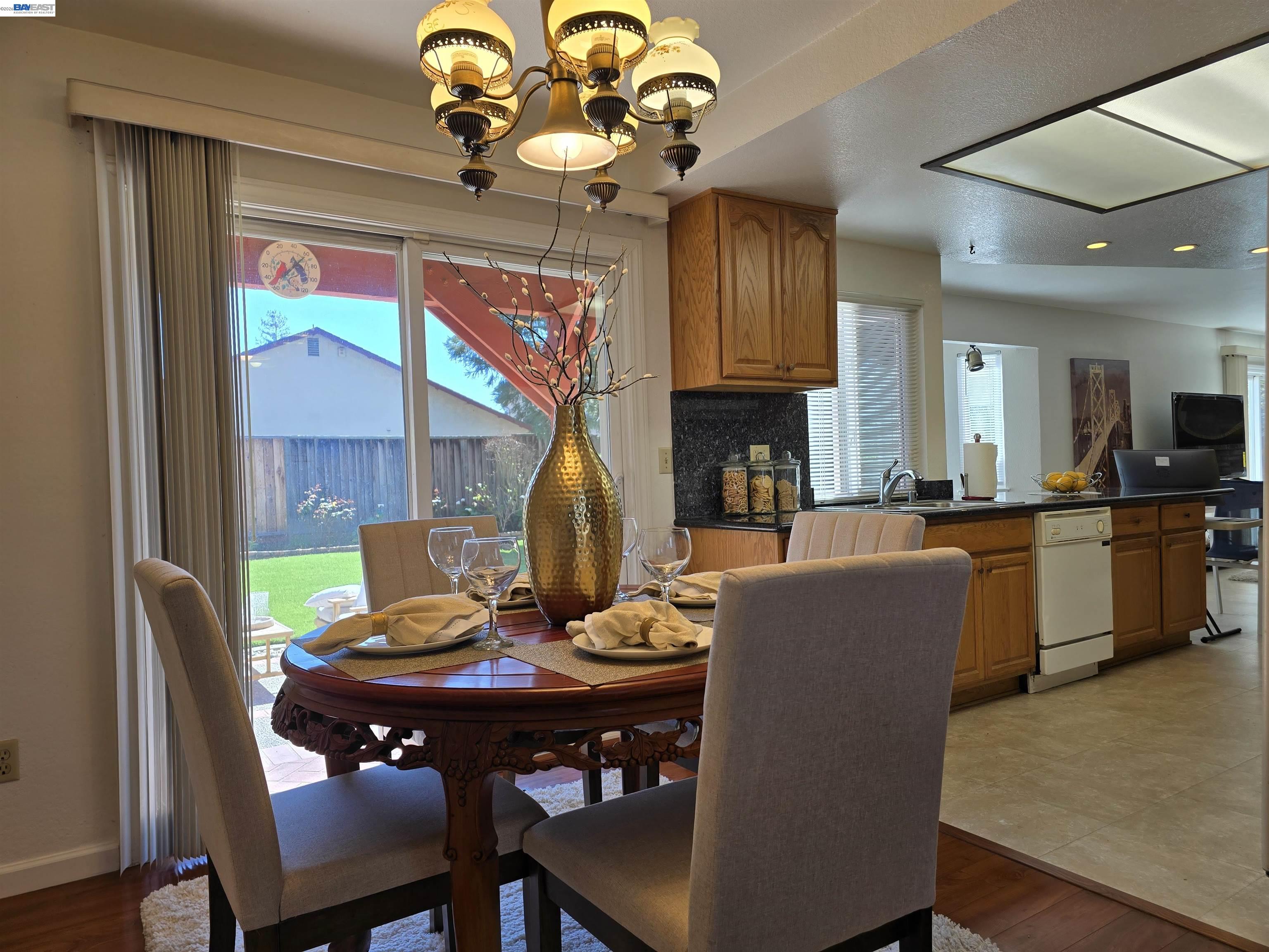 161 Hackamore Lane Fremont, CA 94539 - Photo 17 of 60 a view of a dining room with furniture a chandelier and wooden floor