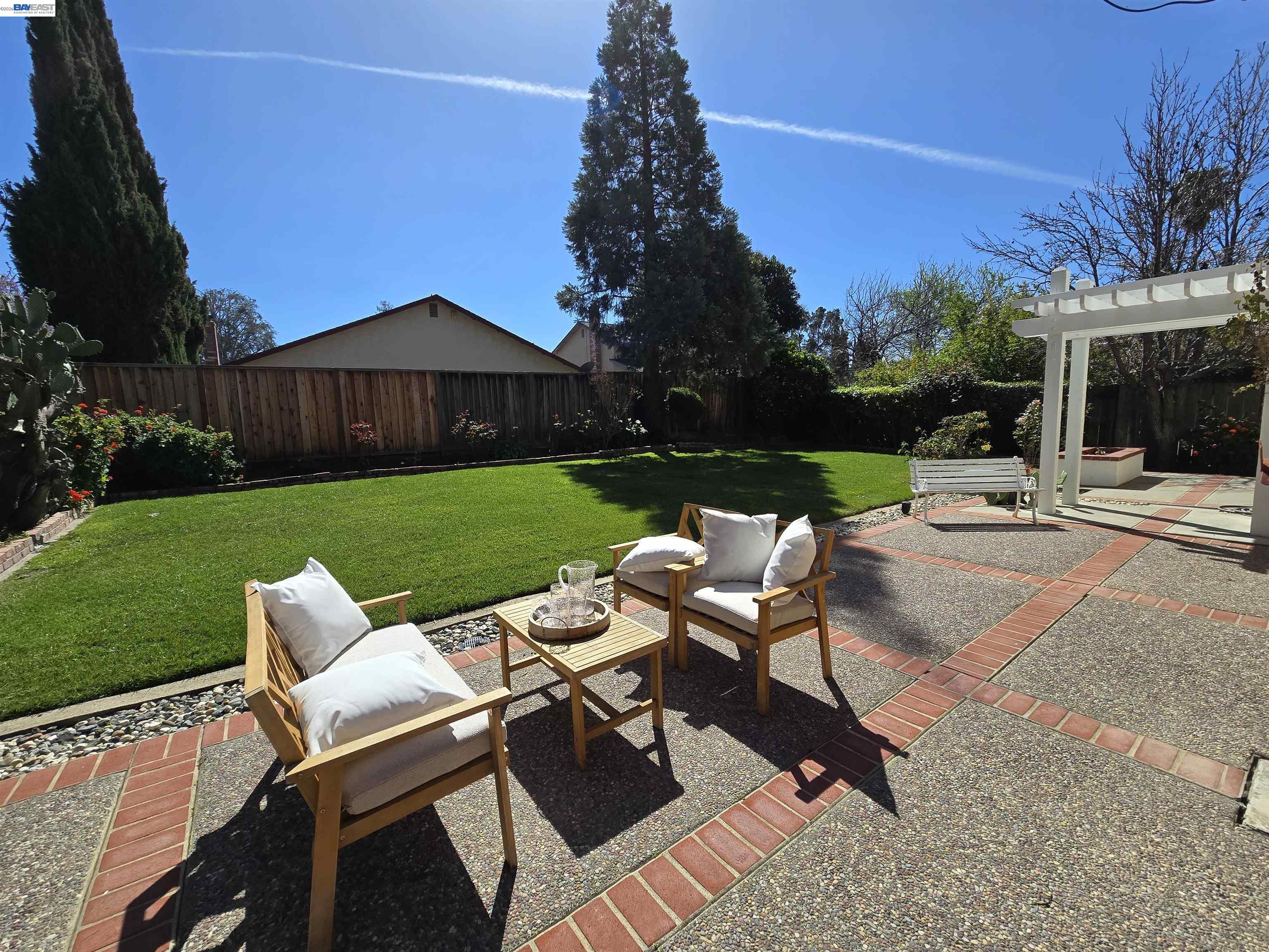 161 Hackamore Lane Fremont, CA 94539 - Photo 20 of 60 a view of a patio with chair and table and chairs under an umbrella