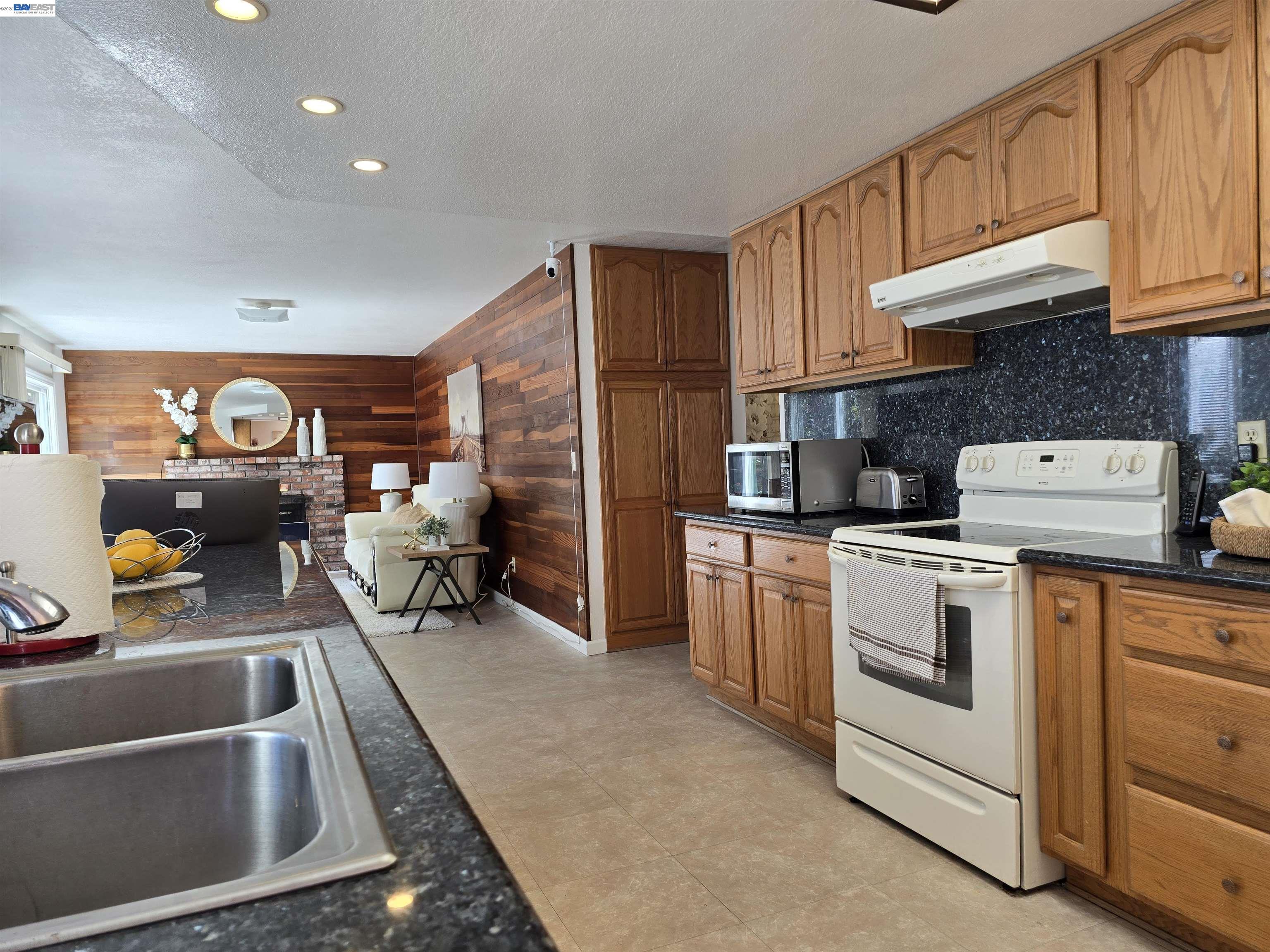 161 Hackamore Lane Fremont, CA 94539 - Photo 22 of 60 a kitchen that has a lot of cabinets a sink and appliances in it