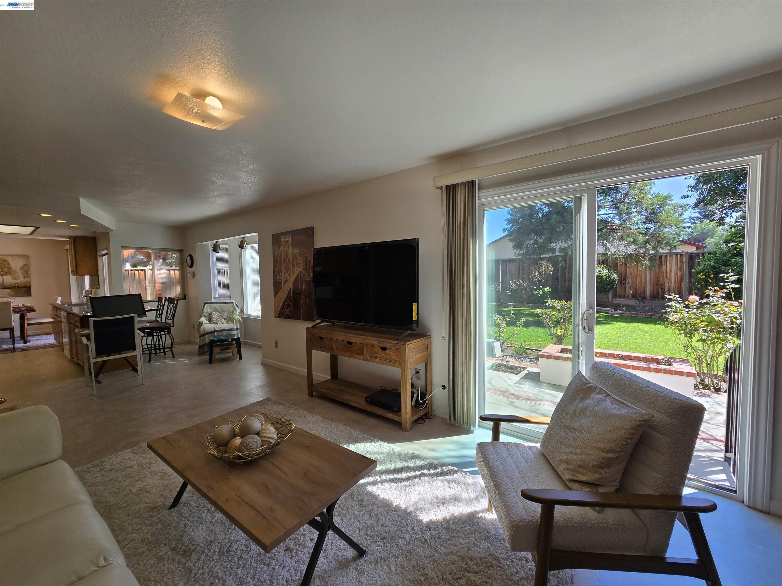 161 Hackamore Lane Fremont, CA 94539 - Photo 30 of 60 a living room with furniture and a flat screen tv