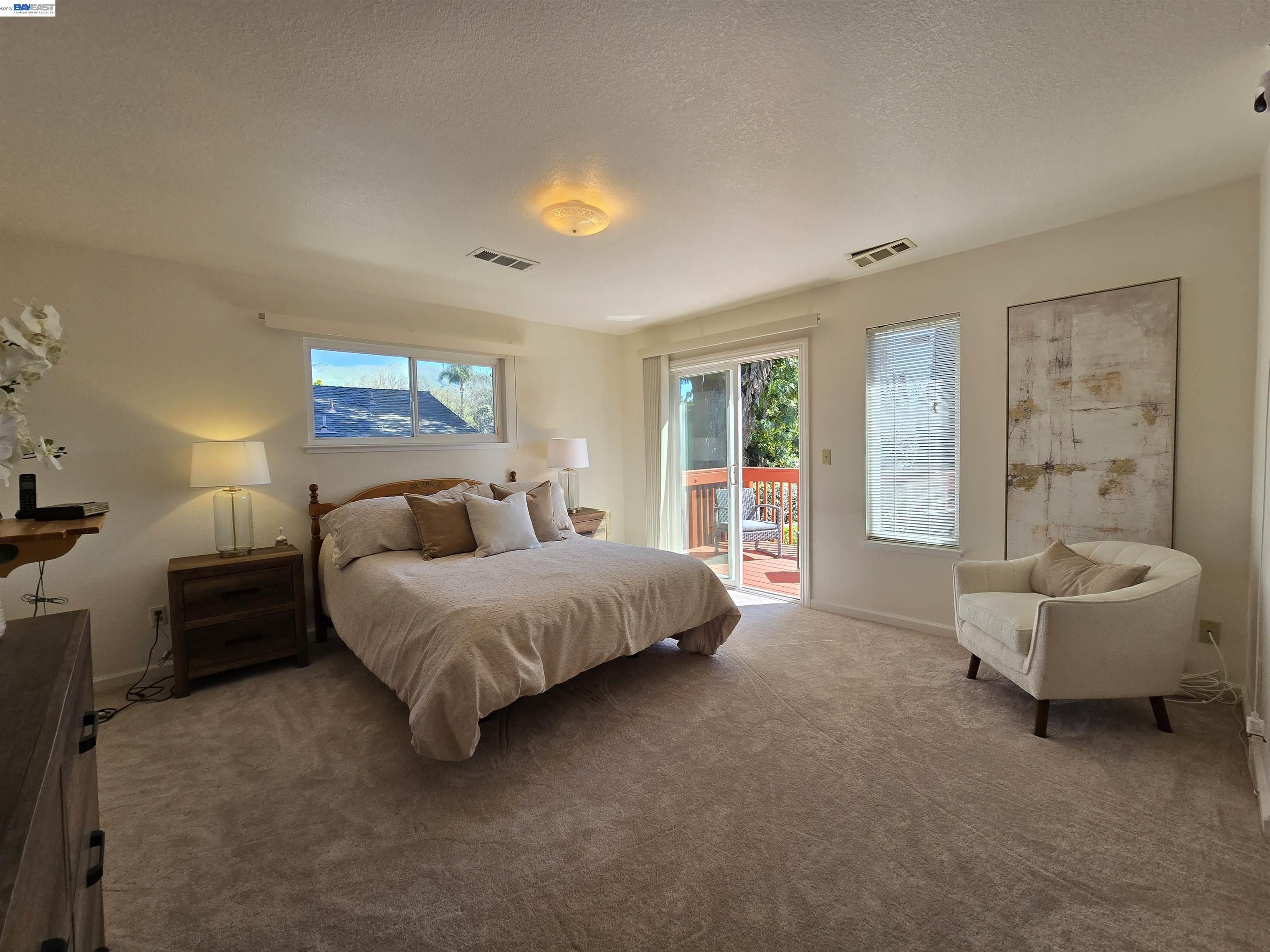 161 Hackamore Lane Fremont, CA 94539 - Photo 40 of 60 a spacious bedroom with a bed and a couch