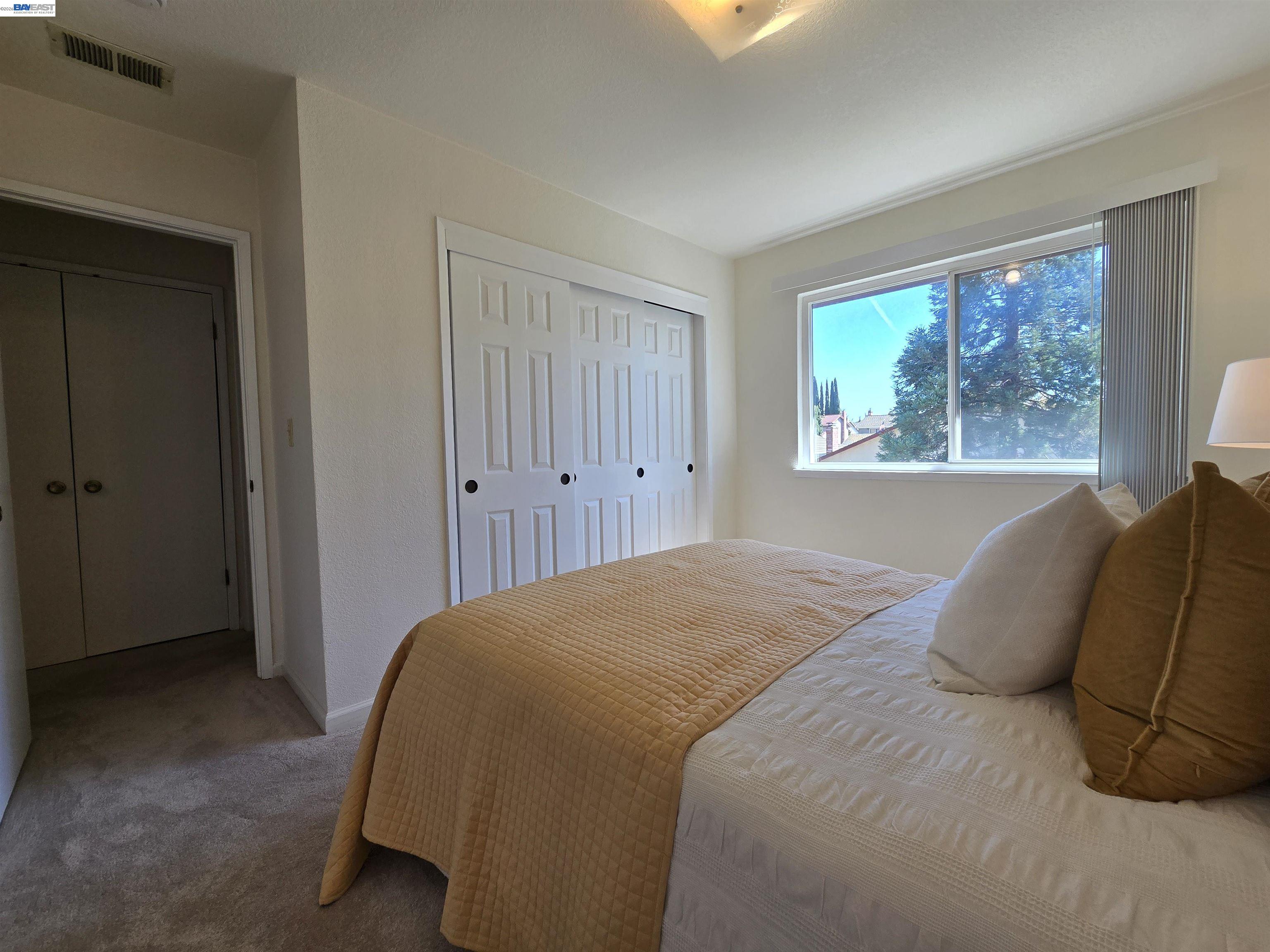 161 Hackamore Lane Fremont, CA 94539 - Photo 54 of 60 a bedroom with a bed and a large window