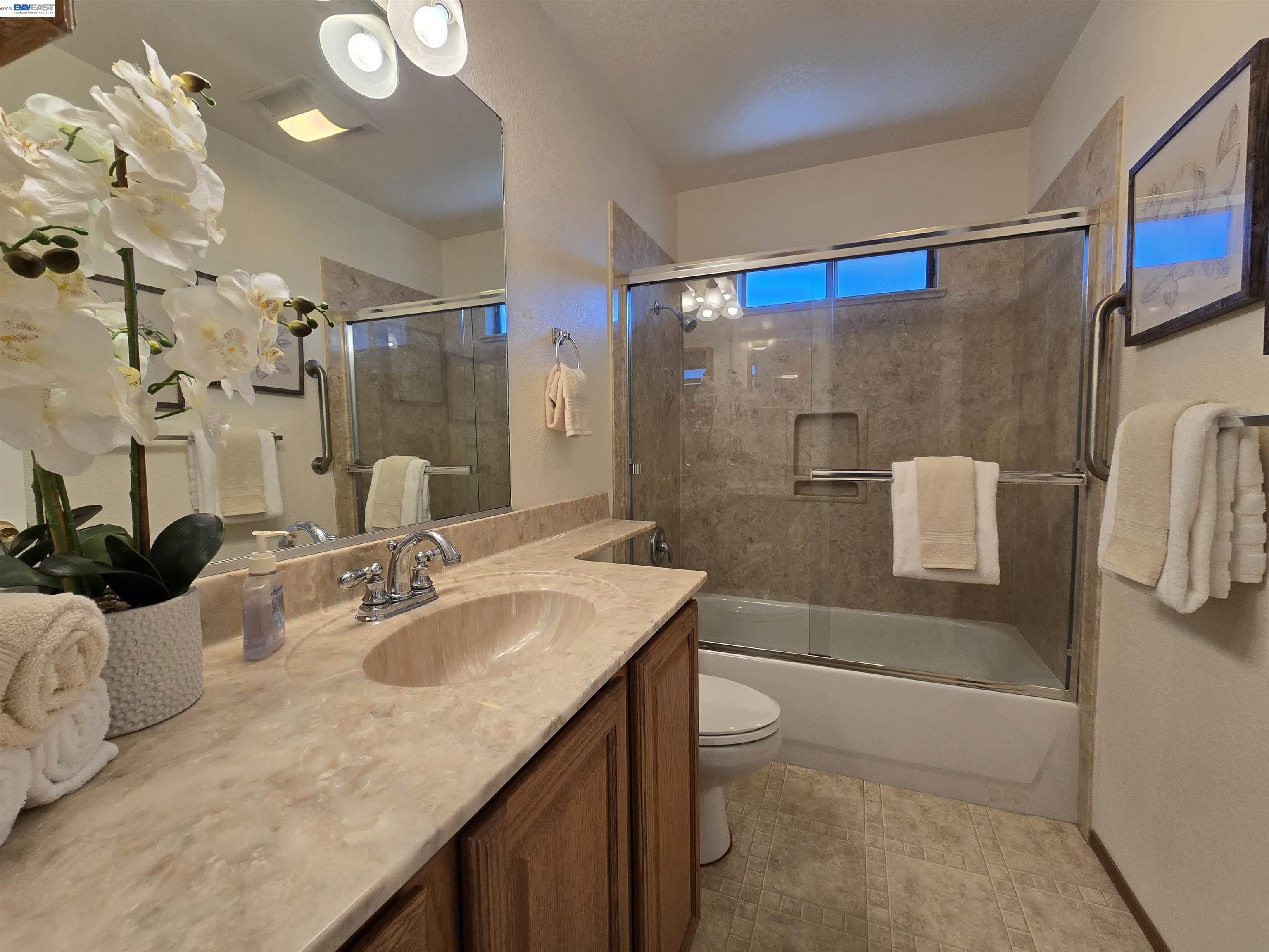 161 Hackamore Lane Fremont, CA 94539 - Photo 55 of 60 a bathroom with a granite countertop sink a toilet and shower