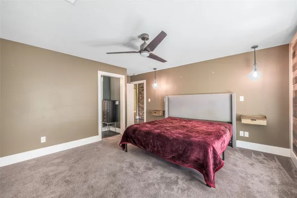 a bedroom with a bed and a lamp