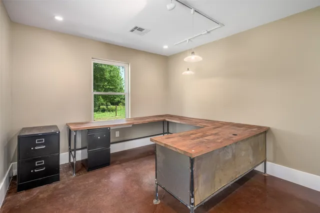 a view of a livingroom with a ceiling fan and window