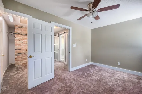 a spacious bathroom with a toilet sink and mirror