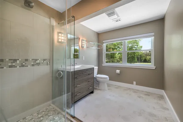 a view of a kitchen with fridge and wooden floor
