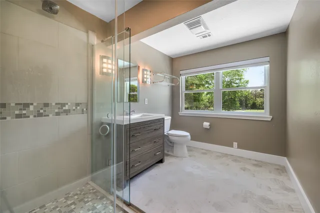 a view of a kitchen with fridge and wooden floor