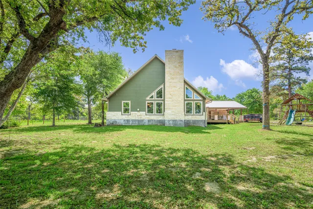 a view of a house with a yard and sitting area