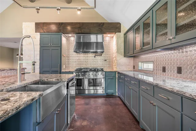 a kitchen with stainless steel appliances granite countertop a sink and stove