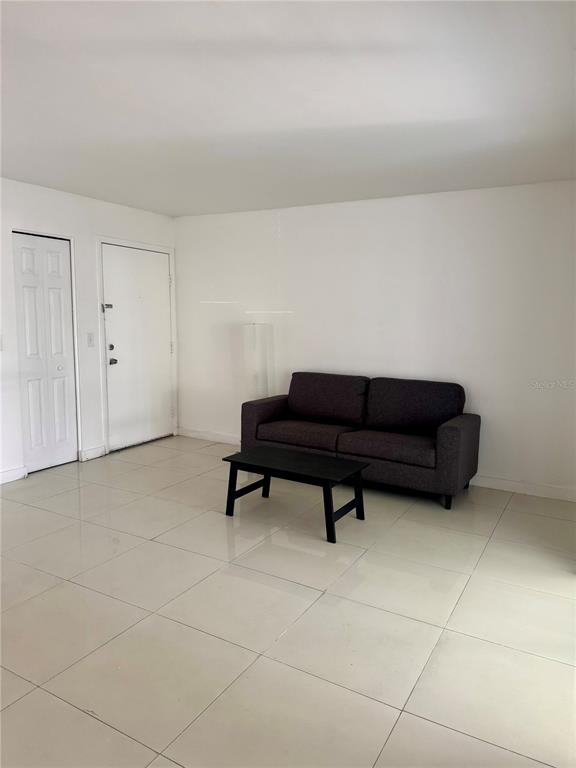 13300 Walsingham Road, Unit 26 Largo, FL 33774 - Photo 3 of 22 a living room with a couch and a coffee table