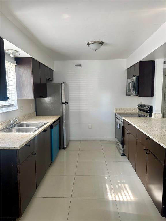 13300 Walsingham Road, Unit 26 Largo, FL 33774 - Photo 6 of 22 a kitchen with a sink cabinets and appliances