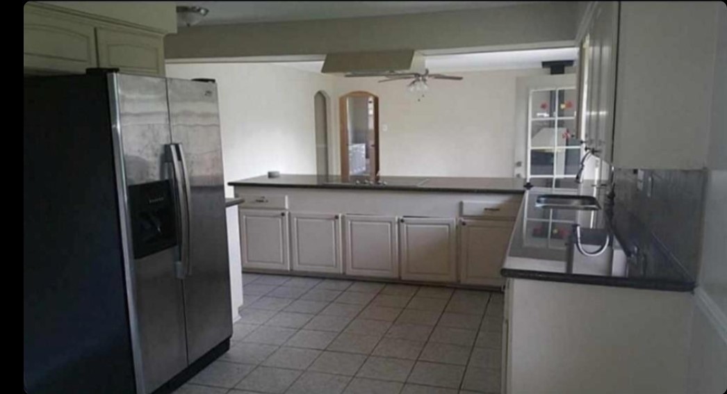 8835 Valley View Lane Houston, TX 77074 - Photo 3 of 8 a kitchen with stainless steel appliances a refrigerator and a stove
