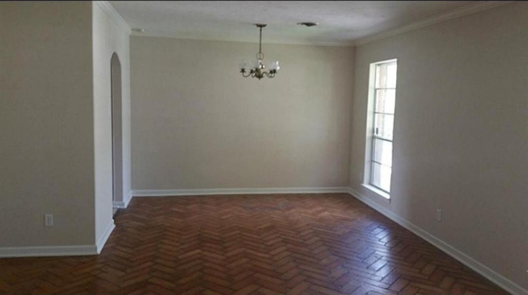 8835 Valley View Lane Houston, TX 77074 - Photo 4 of 8 an empty room with wooden floor and windows