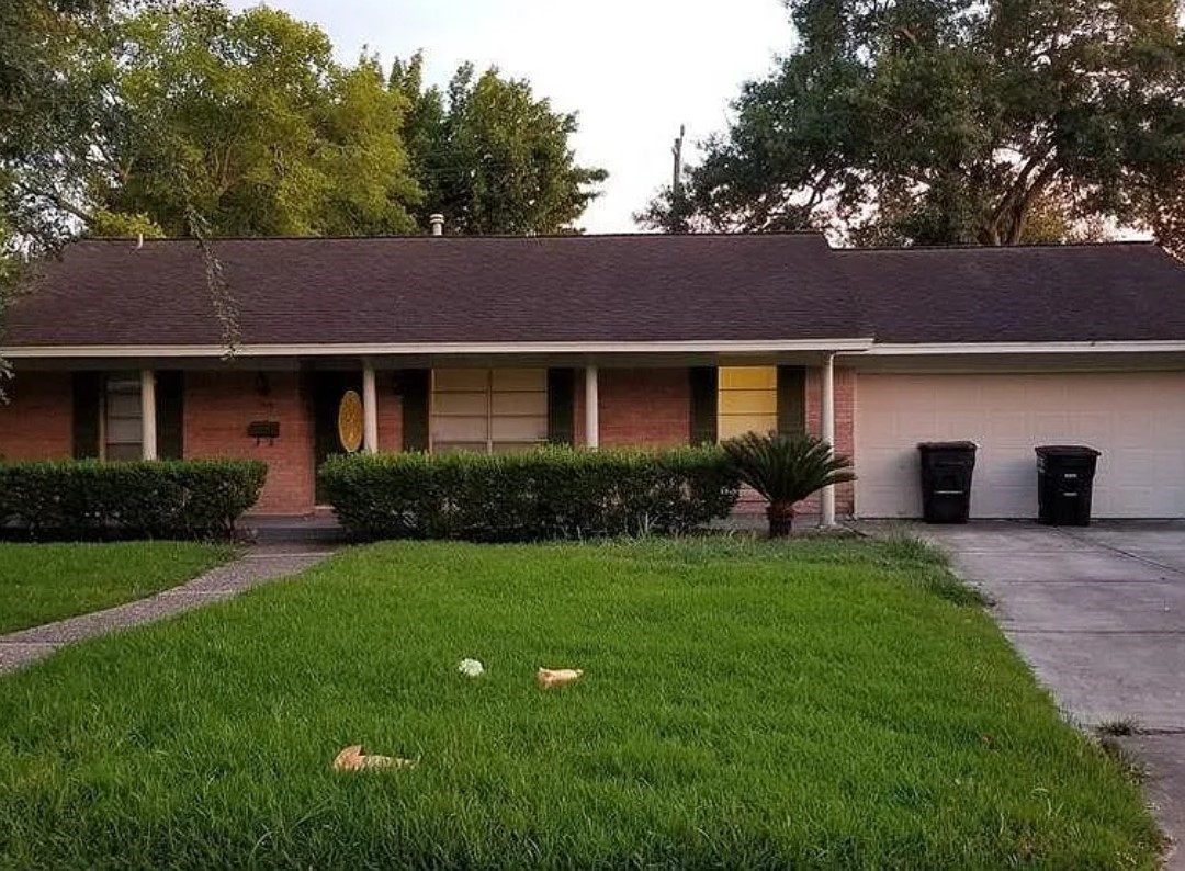 8835 Valley View Lane Houston, TX 77074 - Photo 6 of 8 a front view of a house with a yard and garage