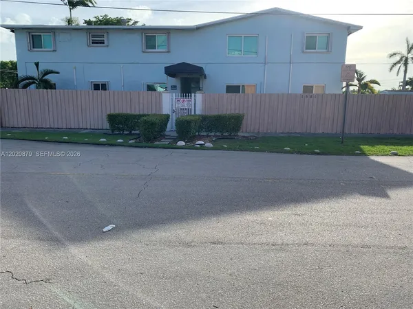 front view of a house with a yard and a garage