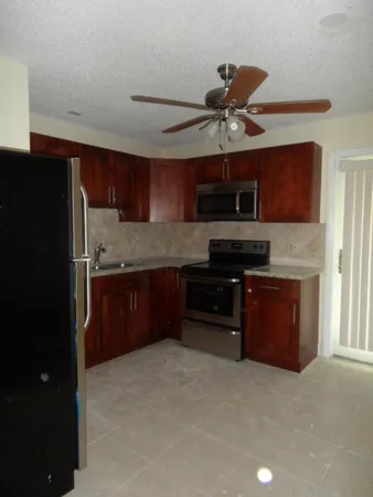 a kitchen with stainless steel appliances granite countertop a stove and a refrigerator