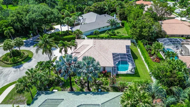 an aerial view of a house with garden space and street view