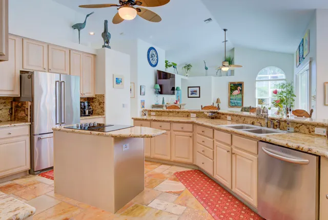 a living room with fireplace furniture and a large window