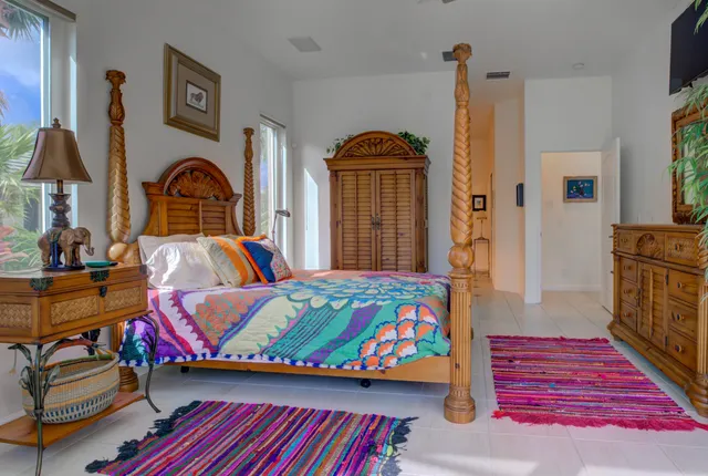 a bed room with a bed and a chandelier