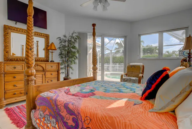 a bed with white sheets and pillows on it