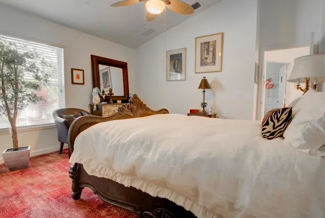 a bedroom with a bed and a painting on the wall