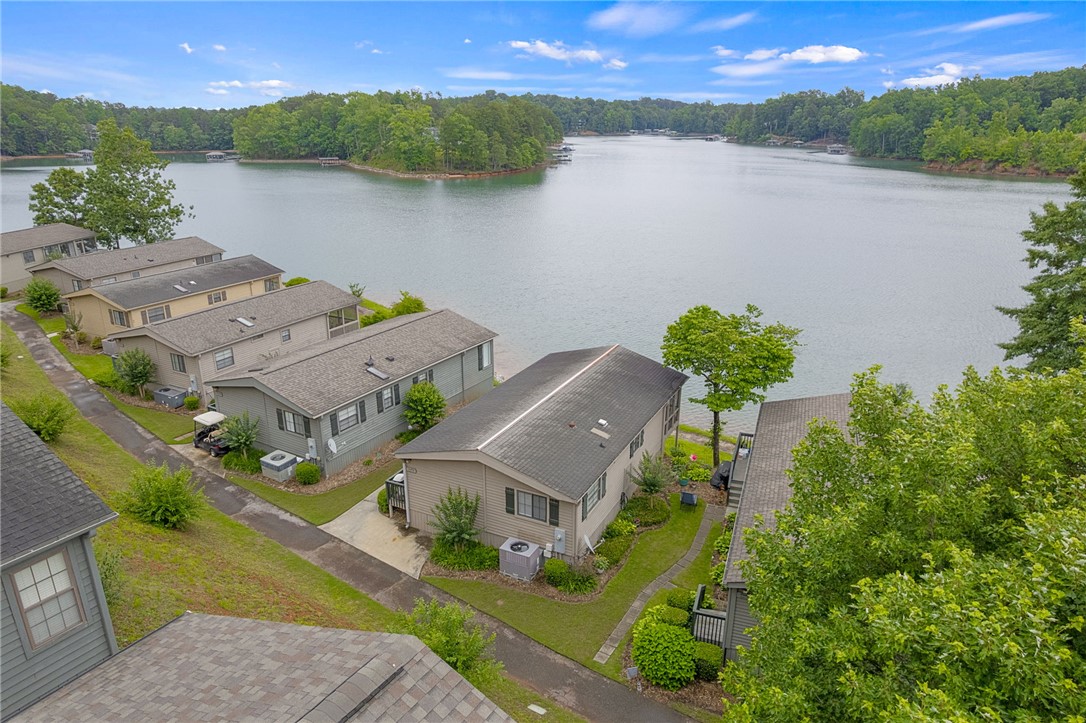 1230 Melton Road, Unit 25 West Union, SC 29696 - Photo 15 of 46 Lakeside living beckons from these charming residences, nestled along a serene waterfront with verdant trees.
