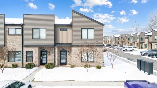 a swimming pool with outdoor seating and yard in the back