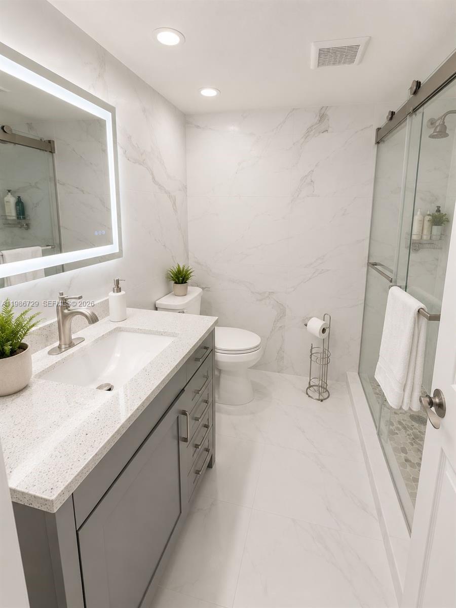 299 Northwest 52nd Terrace, Unit PHX Boca Raton, FL 33487 - Photo 8 of 16 a bathroom with a sink vanity and a toilet
