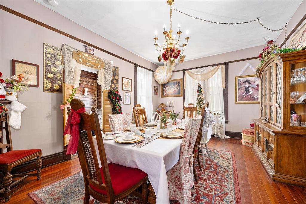 228 West Howry Avenue Deland, FL 32720 - Photo 11 of 51 a view of a dining room with furniture a chandelier and wooden floor