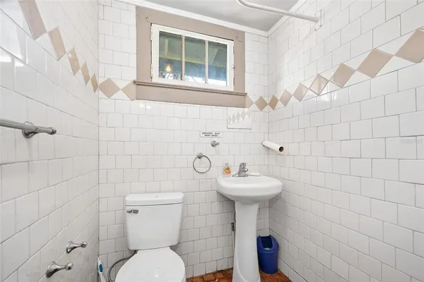 a bathroom with a sink toilet and a mirror