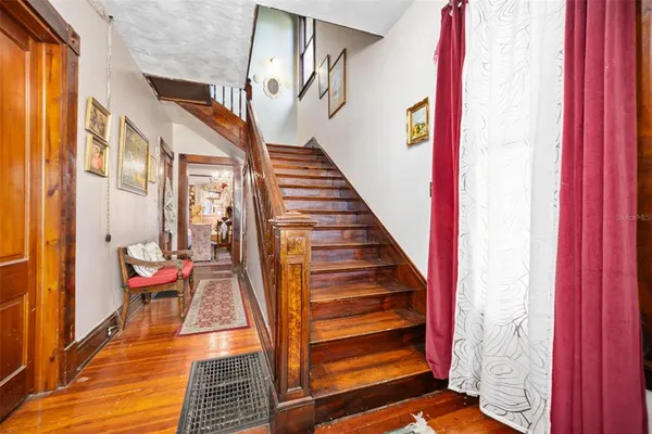 a view of an entryway with wooden floor and door