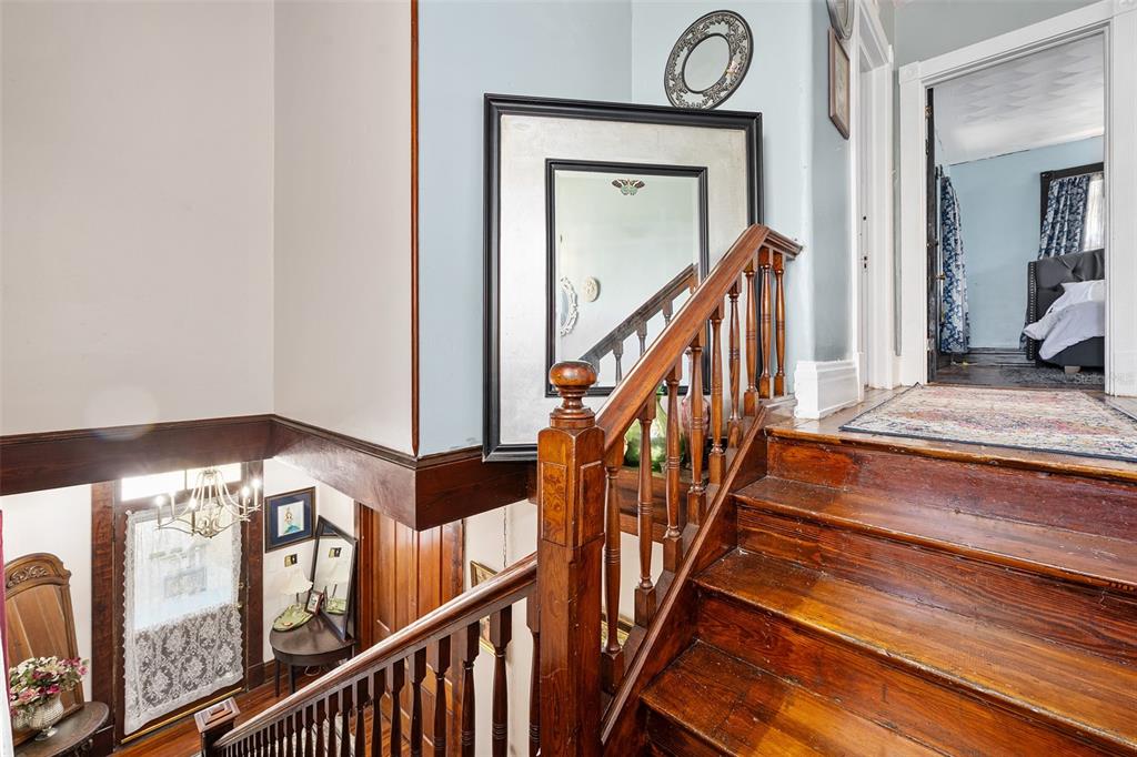 228 West Howry Avenue Deland, FL 32720 - Photo 19 of 51 a view of staircase with railing and a chandelier