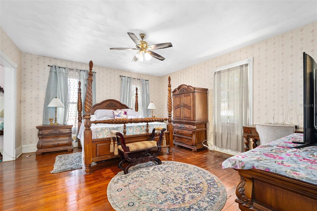 228 West Howry Avenue Deland, FL 32720 - Photo 20 of 51 a bedroom with furniture and a wooden floor