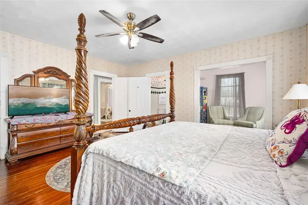 a bedroom with a bed and a chandelier