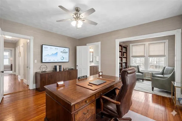 a view of a dining room with furniture a chandelier and wooden floor