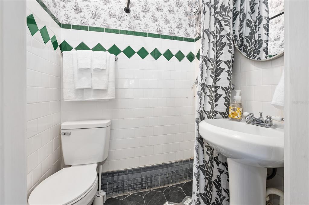 228 West Howry Avenue Deland, FL 32720 - Photo 23 of 51 a bathroom with a sink toilet and mirror