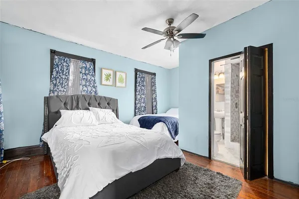 a bedroom with a large bed and a chandelier