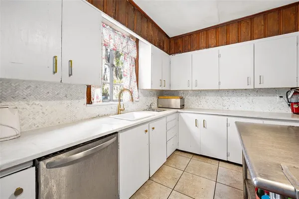 a kitchen with a refrigerator and cabinets