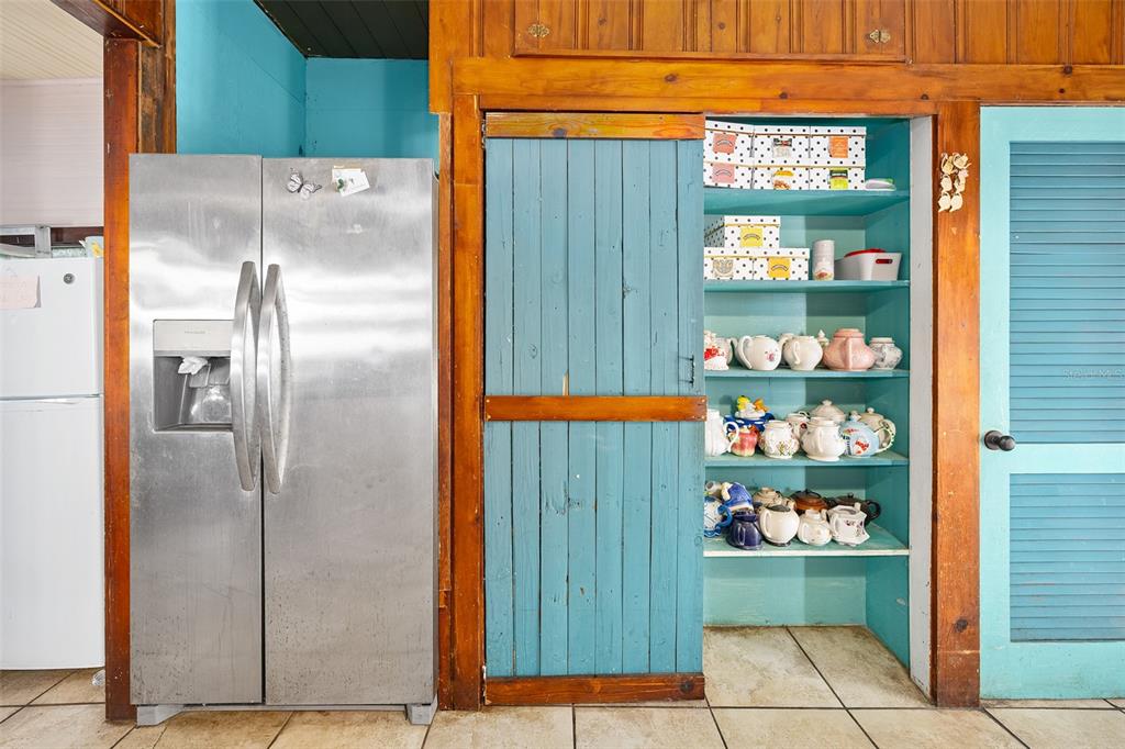 228 West Howry Avenue Deland, FL 32720 - Photo 36 of 51 a kitchen with a refrigerator and cabinets