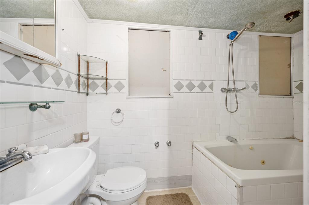 228 West Howry Avenue Deland, FL 32720 - Photo 46 of 51 a bathroom with a toilet a sink and bathtub