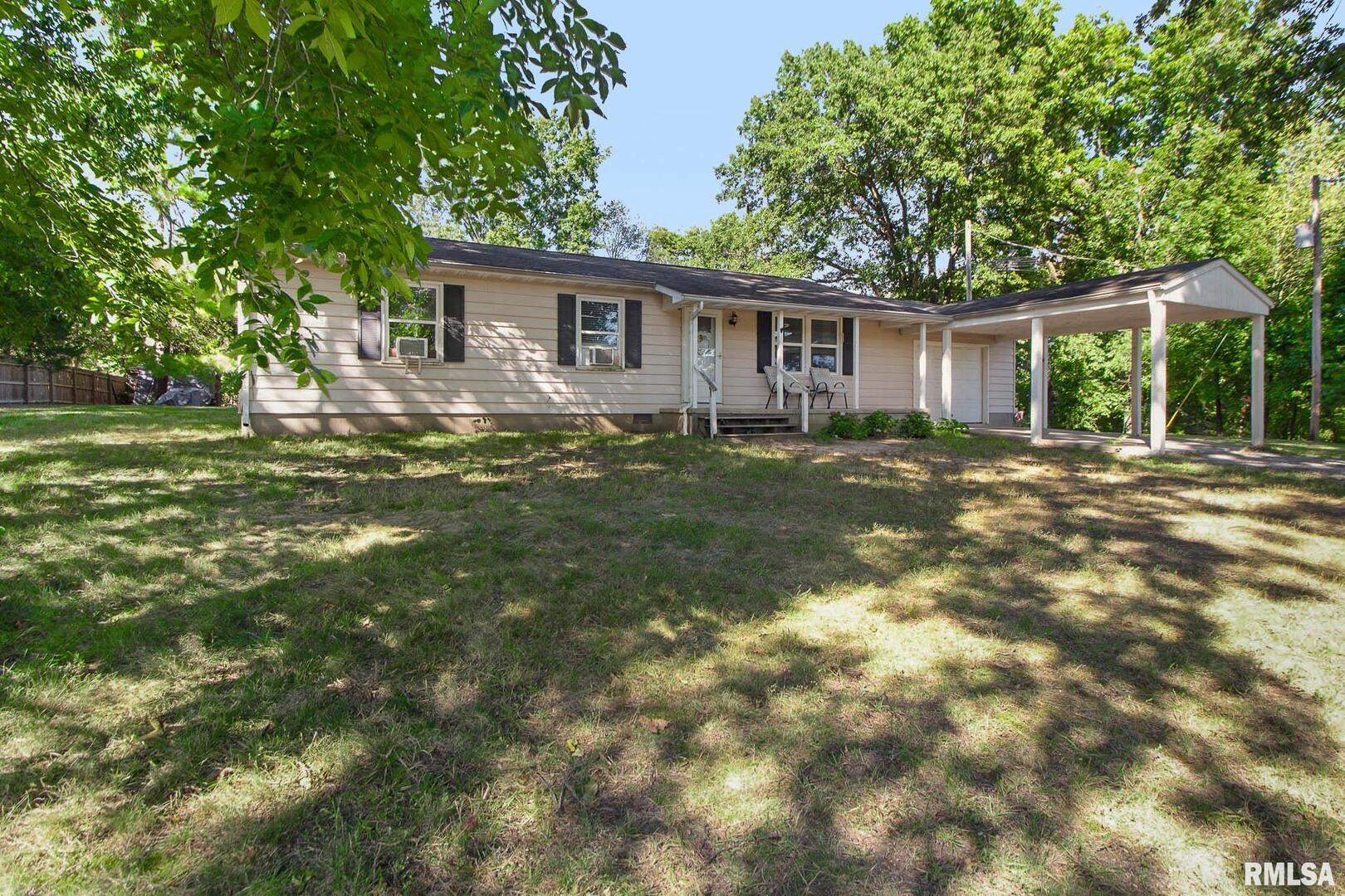 a view of a house with a backyard