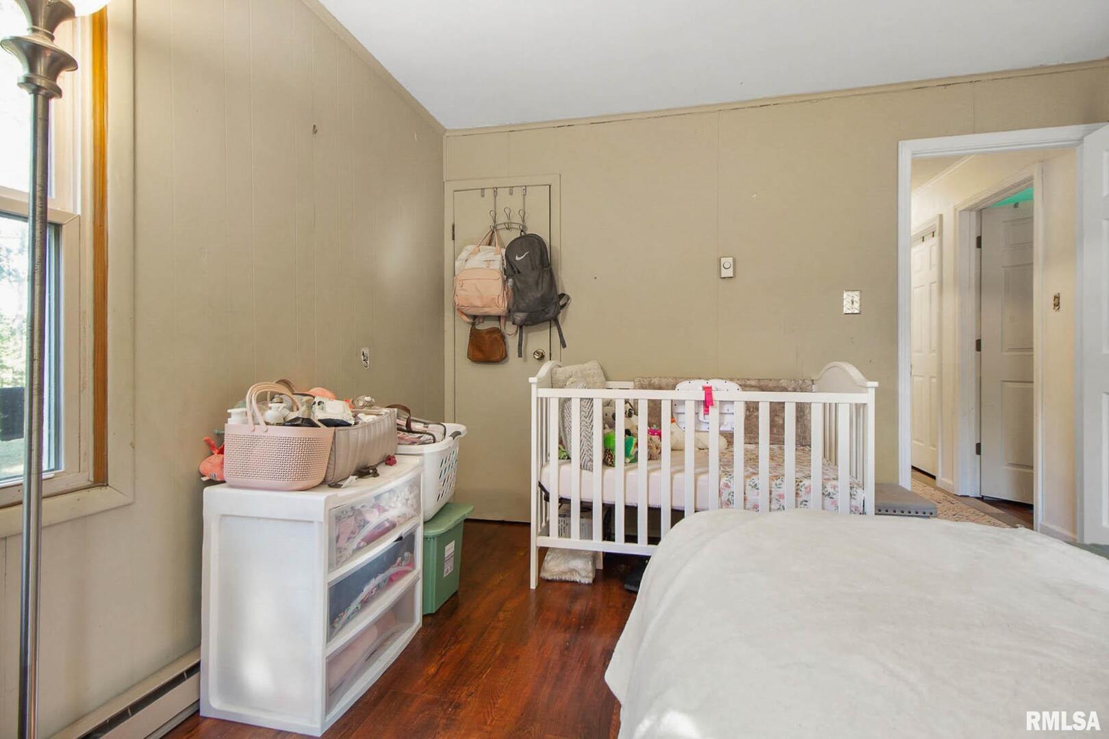 16042 Ralls Grove Road Creal Springs, IL 62922 - Photo 11 of 26 a bedroom with a bed and wooden floor