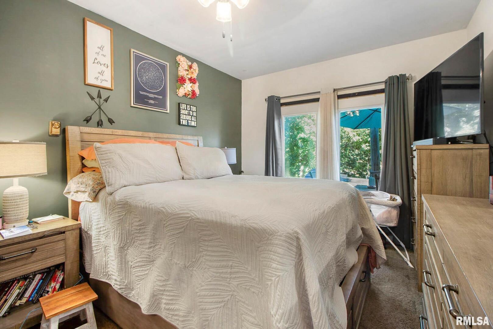 16042 Ralls Grove Road Creal Springs, IL 62922 - Photo 14 of 26 a bedroom with a bed and wooden floor